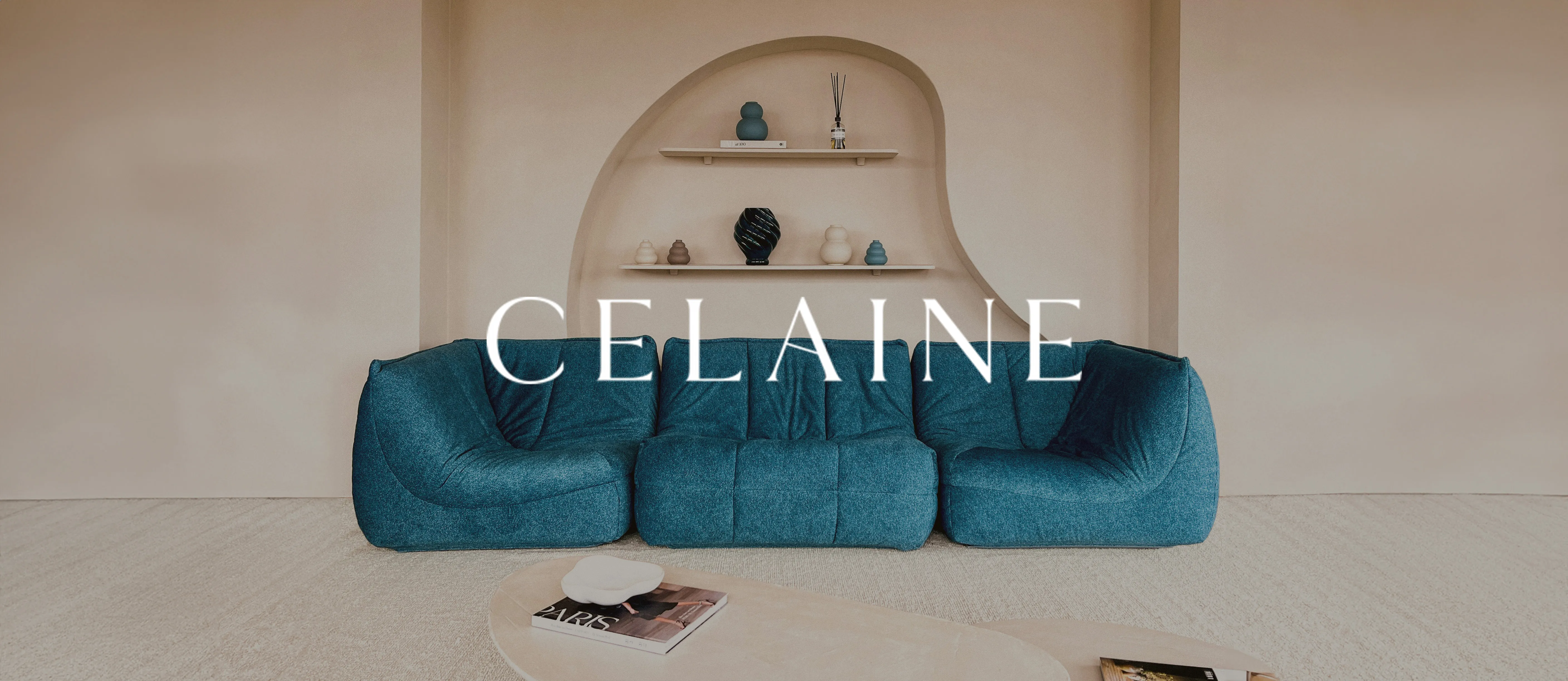 Celaine logotype over a teal modular sofa in front of an arched wall niche