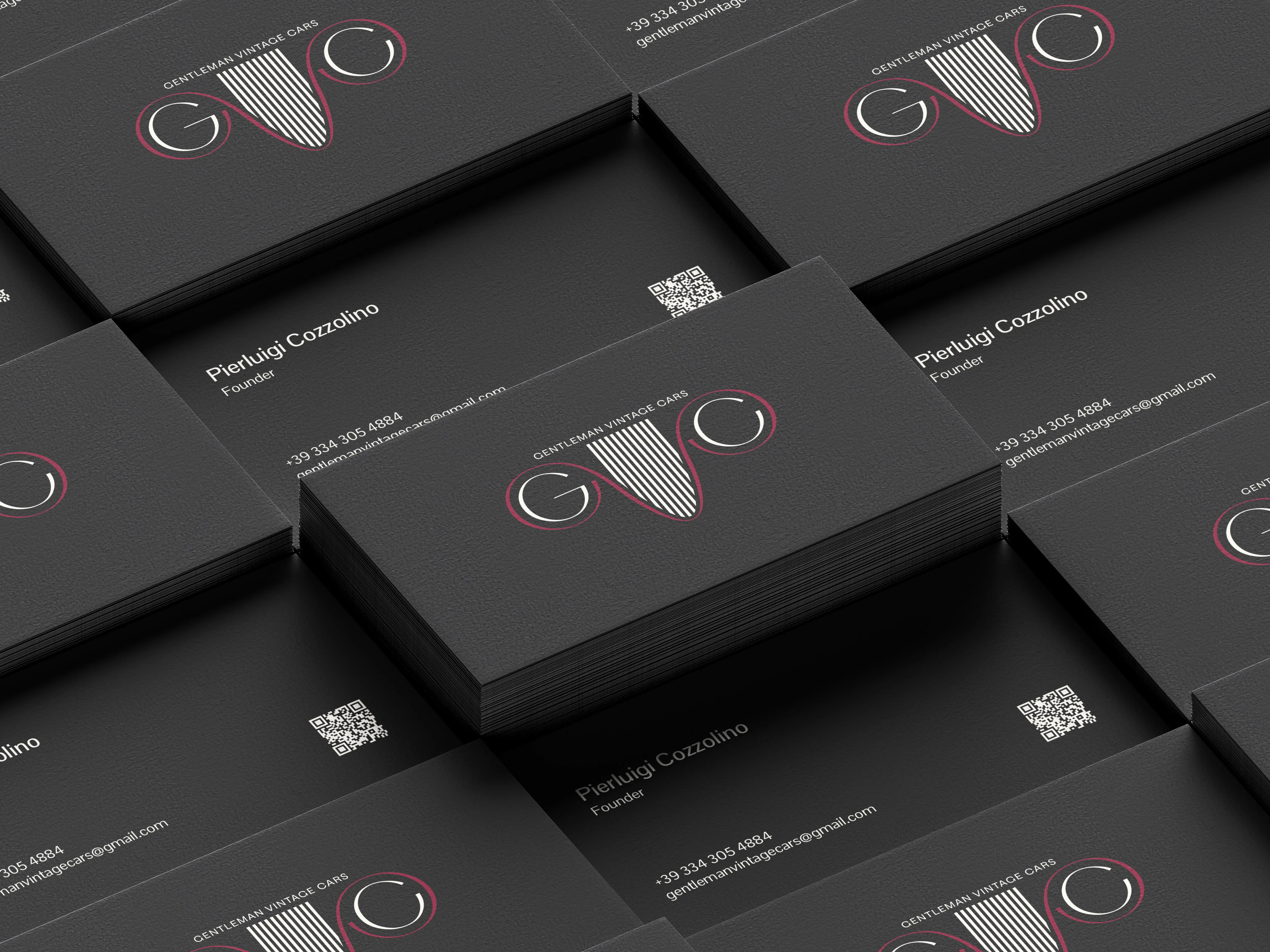 Stacks of black Gentleman Vintage Cars business cards with the GVC monogram