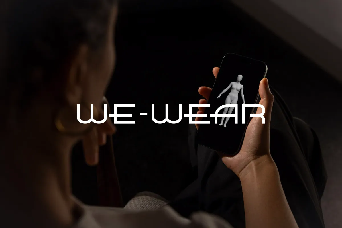 We Wear logo over a woman viewing a 3D body model on her phone
